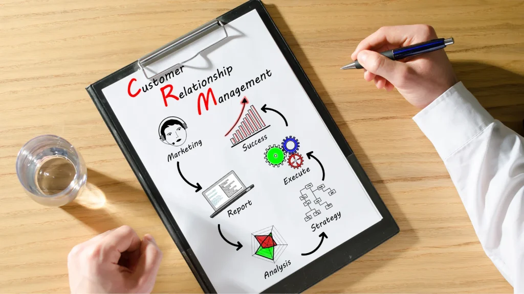 Hand drawing a CRM process diagram on paper with arrows stages and workflow icons
