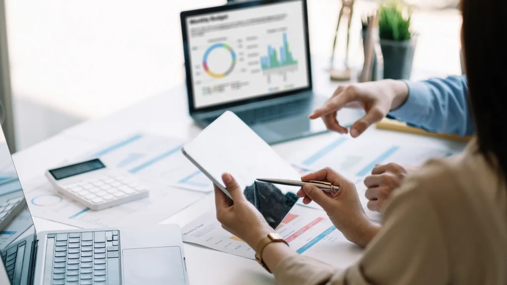 Business professionals analyzing complex AWS reports representing the challenges of disconnected and siloed cloud data